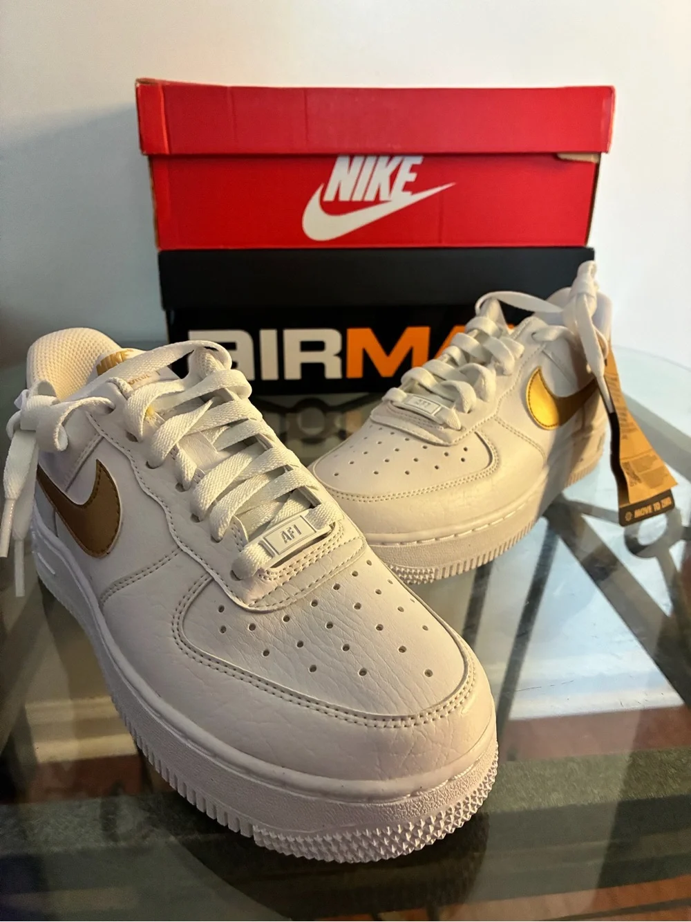 Nike White Sneakers with Gold Swoosh